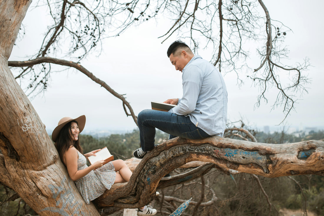 couple sitting in a tree reading