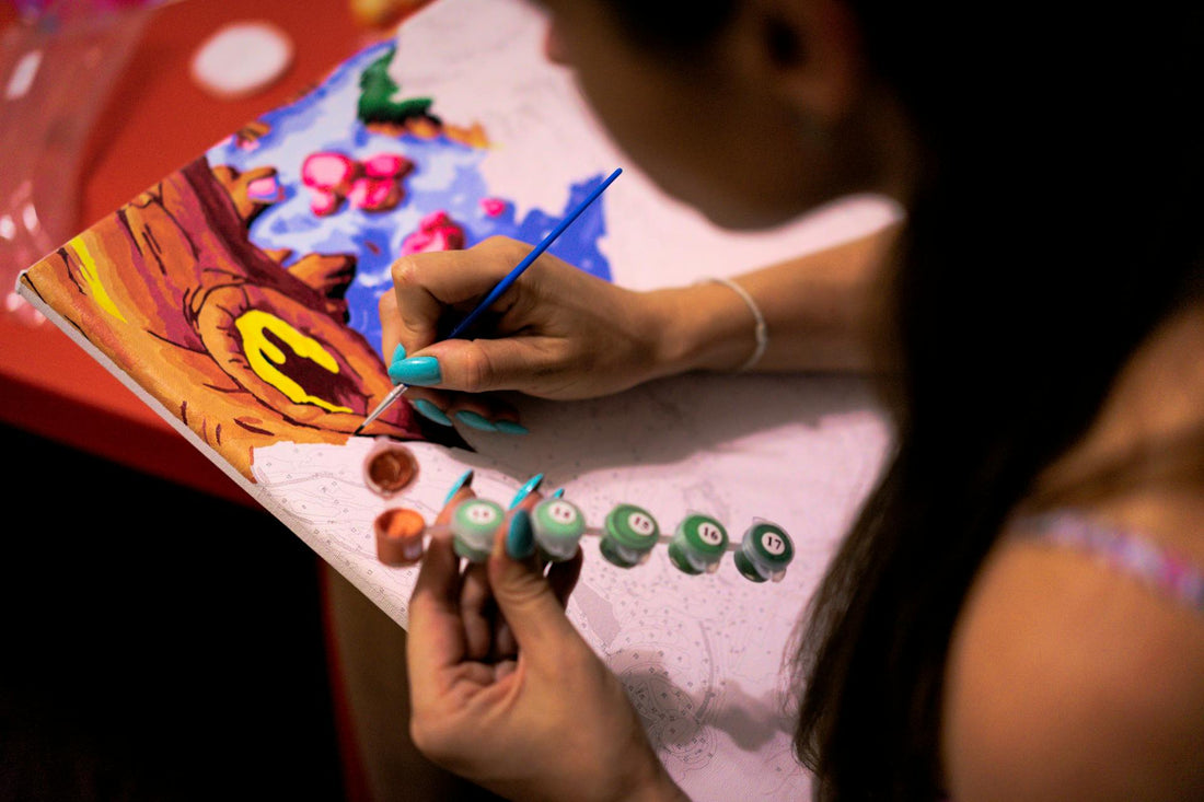 Woman painting a paint by numbers